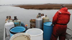 An EPA crew heads back to unload the containers for sorting and proper disposal after an afternoon searching for hazardous containers along Captree Island in New York, following Hurricane Sandy. These tanks and many smaller containers held below deck were found by EPA and contractor boat crews.