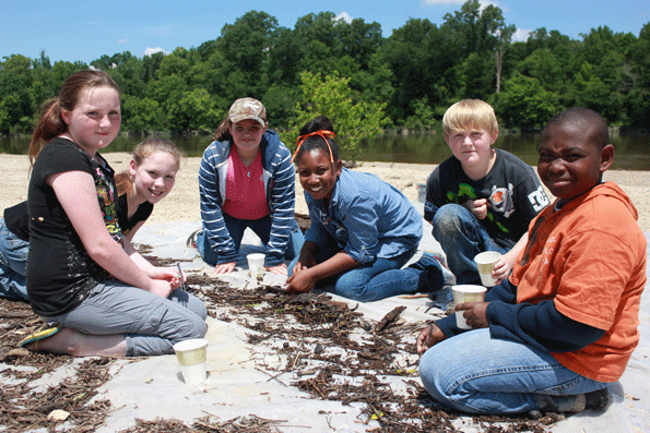 Fifthgrade students from New Augusta Elementary pause from collecting and identifying aquatic insects from the Leaf River during a May 2013 Discovery Day field trip part of GeorgiaPacific39s environmental education program at its New Augusta Miss site Photo Business Wire