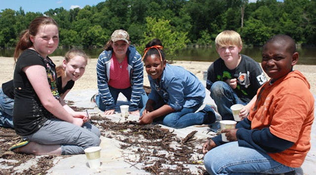 Fifth-grade students from New Augusta Elementary pause from collecting and identifying aquatic insects from the Leaf River during a May 2013 Discovery Day field trip, part of Georgia-Pacific&apos;s environmental education program at its New Augusta, Miss., site. (Photo: Business Wire)