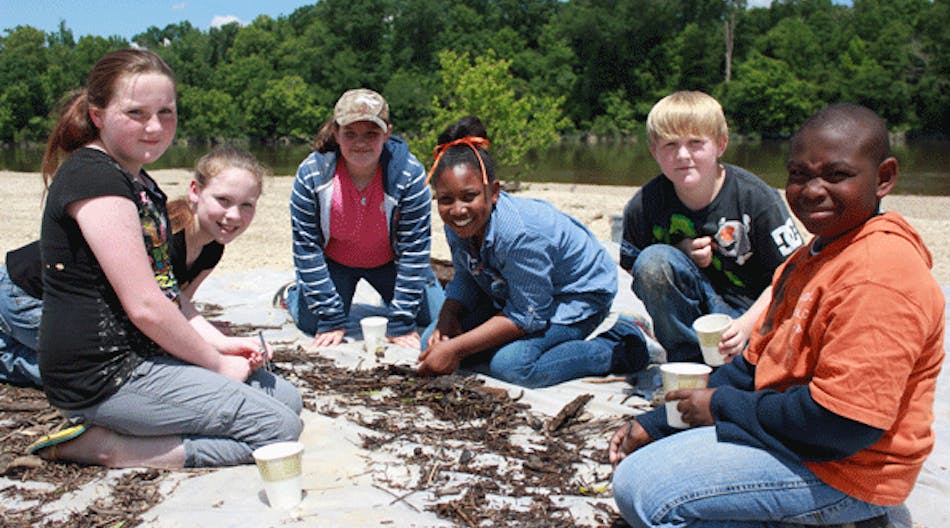 Fifth-grade students from New Augusta Elementary pause from collecting and identifying aquatic insects from the Leaf River during a May 2013 Discovery Day field trip, part of Georgia-Pacific&apos;s environmental education program at its New Augusta, Miss., site. (Photo: Business Wire)