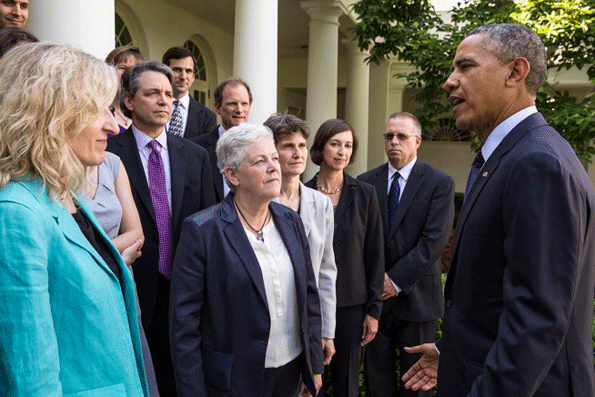 President Barack Obama with Environmental Protection Agency Administrator Gina McCarthy center talks with EPA staff members who worked on the powerplant emissions standards in the Rose Garden of the White House June 2