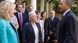 President Barack Obama, with Environmental Protection Agency Administrator Gina McCarthy, center, talks with EPA staff members who worked on the power-plant emissions standards, in the Rose Garden of the White House, June 2.