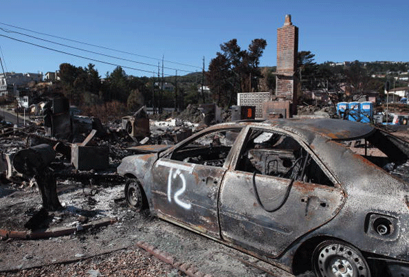 The shell of a car sits in the driveway of a burned home near the epicenter of the PGampE gasline explosion that devastated a neighborhood near San Francisco International Airport on Sept 24 2010 in San Bruno California