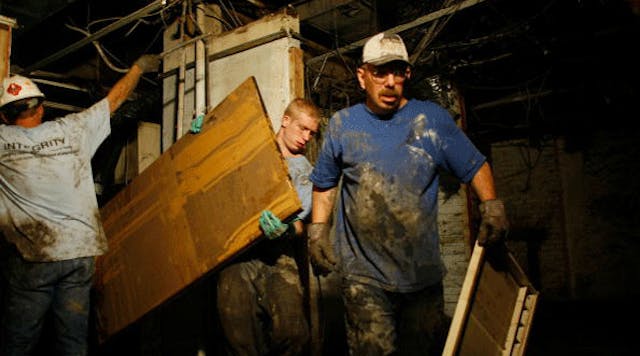 Workers clean out the basement of an office building after the Cedar River inundated it with flood waters June 22, 2008 in Cedar Rapids, Iowa.