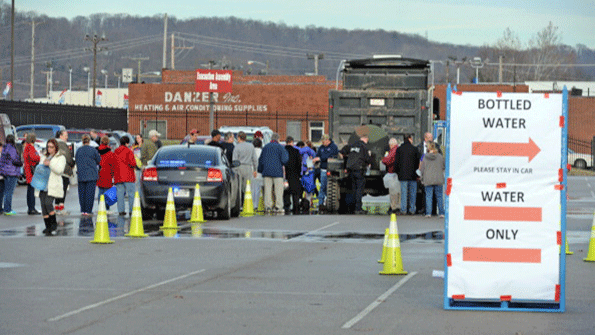 West Virginia American Water customers line up for water at the Gestamp Plant after waiting hours for a water truck only to have it emptied in about 20 minutes on Jan 10 in South Charleston W Va The lives of 300000 people were disrupted and schools and businesses were closed for days following the chemical leak from Freedom Industries and subsequent water contamination Photo by Tom HindmanGetty Images