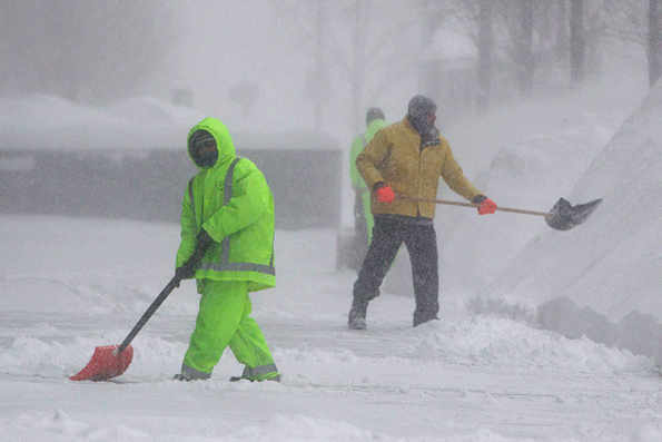 Workers shovel sidewalks on Boston39s Boylston Street during winter storm Neptune which dropped over a foot of snow Feb 15 in Boston This is the fourth major storm to hit the New England region that has already seen more than 6 feet of snow in some areas