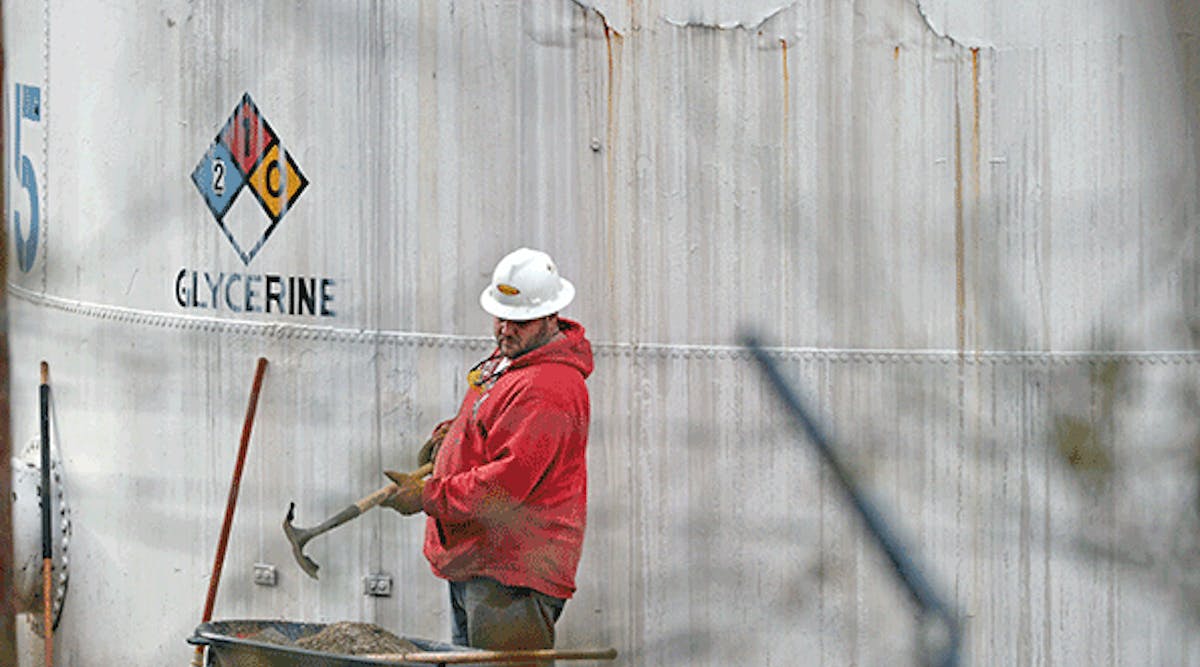 An unidentified worker at Freedom Industries shovels NAPA premium oil absorbent on Jan. 10, 2014 in Charleston, W.Va. West Virginia American Water determined MCHM chemical had overwhelmed the plant&apos;s capacity to keep it out of the water from a spill at Freedom Industries in Charleston. An unknown amount of the hazardous chemical contaminated the public water system for potentially 300,000 people in West Virginia.
