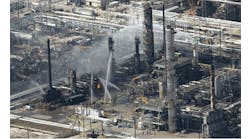 Emergency crews struggle to put out the fire from a blast that killed 15 workers and injured nearly 200 more at BP&apos;s Texas City, Tex., oil refinery on March 23, 2005.