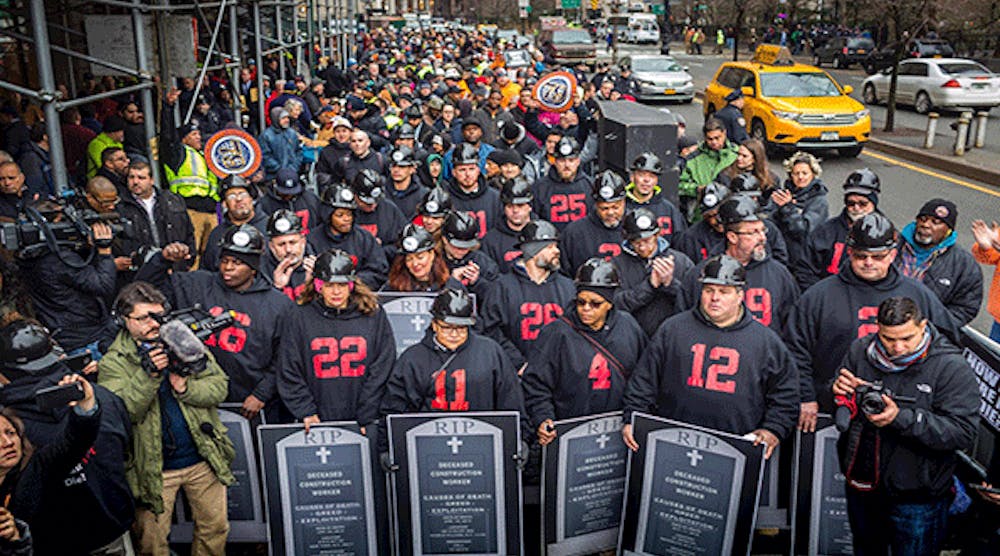 Photographer Michael Nigro captured this photo of hundreds of construction workers and union members who demonstrated in lower Manhattan on Jan. 18, 2017, in a planned act of civil disobedience. They are carrying coffins and grave markers representing the construction workers who have died in New York in recent months. Thirty-one people were &apos;arrested,&apos; to symbolize the 31 construction site deaths that have occurred in New York City in the past 24 months.