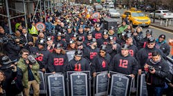 Photographer Michael Nigro captured this photo of hundreds of construction workers and union members who demonstrated in lower Manhattan on Jan. 18, 2017, in a planned act of civil disobedience. They are carrying coffins and grave markers representing the construction workers who have died in New York in recent months. Thirty-one people were &apos;arrested,&apos; to symbolize the 31 construction site deaths that have occurred in New York City in the past 24 months.