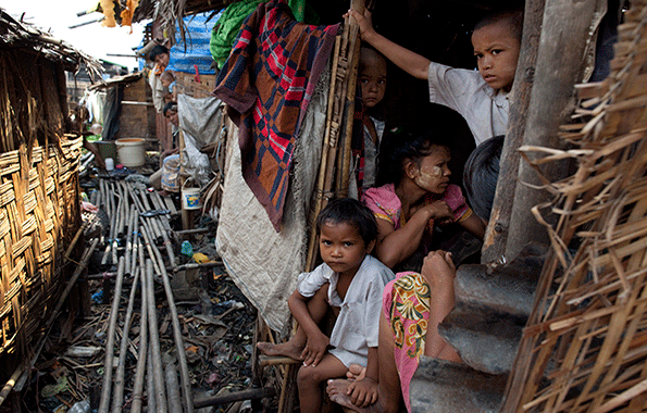 Burmese children live in squalor in small huts without proper sanitation in the slum area of Hlaing Thaya Yangon Myanmar Burma The Burmese government spends only 03 percent of its gross domestic product on health the lowest amount worldwide