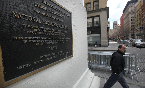 A man walks past the Asch building in New York City the site of the infamous Triangle Shirtwaist Factory fire that killed 146 immigrant workers most of them young women Workers were locked into the factory during their shifts preventing escape New Yorkers watched in horror from below as workers leapt to their deaths from the windows above Public outcry over the tragedy led to nationwide debate on workers rights and safety regulations and helped pave the way for strong workers unions