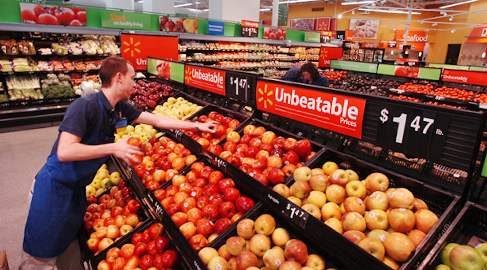 A Wal-Mart associate stocks produce in a Wal-Mart Supercenter store.