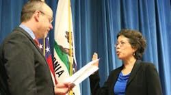 Juliann Sum receive the oath of office from California Labor Secretary David Lanier.