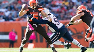 Cleveland Browns quarterback Charlie Whitehurst (#15) is sacked by defensive tackle Malcom Brown (#90) of the New England Patriots at FirstEnergy Stadium on Oct. 9 in Cleveland. The Patriots defeated the Browns 33-13.