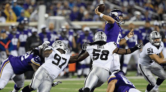 Taylor Heinicke (#6 of the Minnesota Vikings) throws the ball under pressure form Mario Jr. Edwards (#97), Neiron Ball (#58) and Ben Heeney (#51) of the Oakland Raiders during the third quarter of the preseason game on Aug. 22 at TCF Bank Stadium in Minneapolis. The Vikings defeated the Raiders 20-12.