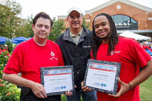 Matt Manock center of Anthem Blue Cross and Blue Shield presents Bob Harrington left and Brandon Booker right with the 2013 Peninsula Lifestyle Change Award Harrington has lost 85 pounds and Booker has lost 140 pounds as a result of healthy lifestyle changes Photo by Dar Deerfield Mook