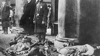 Police officers stand watch over the bodies of Triangle Shirtwaist factory workers who jumped to their deaths on March 25, 1911 rather than burn to death.
