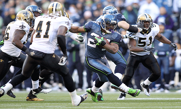 Marshawn Lynch 24 of the Seattle Seahawks runs the ball against the New Orleans Saints during the 2011 NFC wildcard playoff game at Qwest Field on January 8 2011 in Seattle Washington