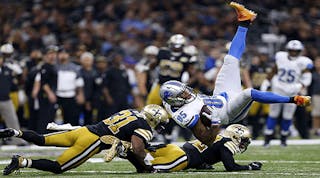 Eric Ebron #85 of the Detroit Lions is tackled by Jairus Byrd #31 of the New Orleans Saints and Kenny Vaccaro #32 during the first half of a game at the Mercedes-Benz Superdome on Dec. 4, 2016 in New Orleans.