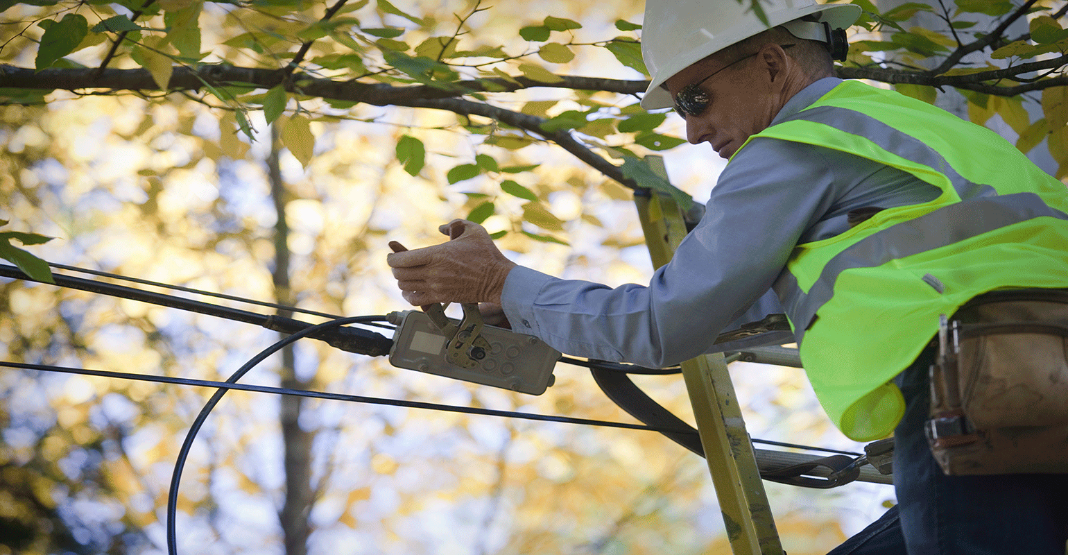 utlity worker repairing power line