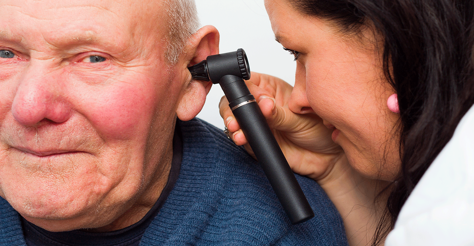 man being check by audiologist