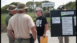 FBI agents confront protestors at the gate of the Arkema plant, which received major damage from flooding caused by Hurricane and Tropical Storm Harvey on Sept. 4 in Crosby, Texas. Authorities enacted an evacuation order for a 1.5-mile perimeter around th