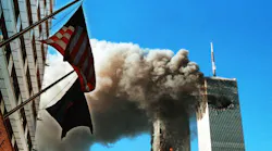Smoke pours from the World Trade Center on September 11 2001 after it was hit by two planes in a coordinated terrorist attack Photo by Craig AllenGetty Images