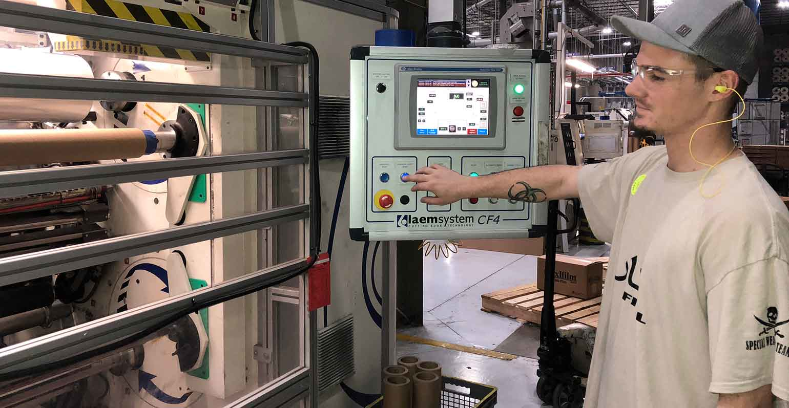 Intertape employee at screen in factory