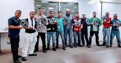 Employees at a meeting on hand safety received foam baseball mitts Employees at a meeting on hand safety received foam baseball mitts