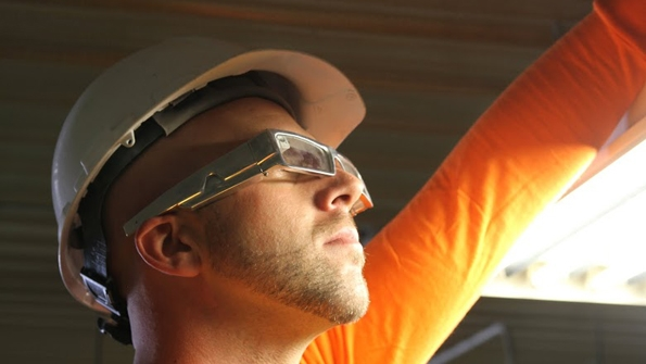 Worker in hardhat wearing xoeye smart glasses