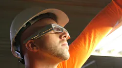 Worker in hardhat wearing xoeye smart glasses