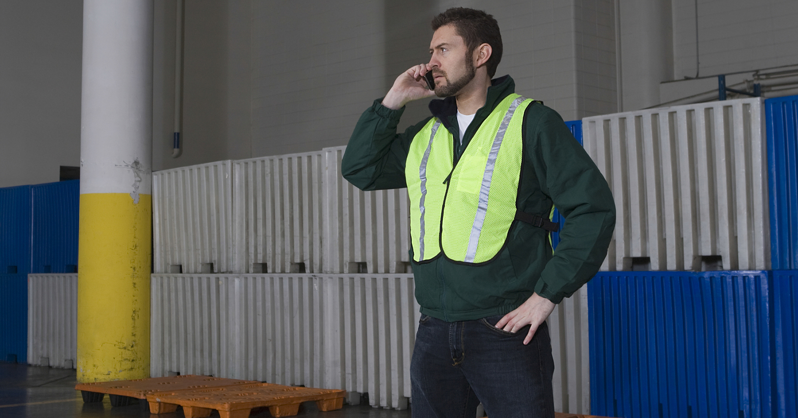 Man Using Cellphone In Warehouse 5ee28f3324ebc