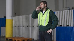 Man Using Cellphone In Warehouse