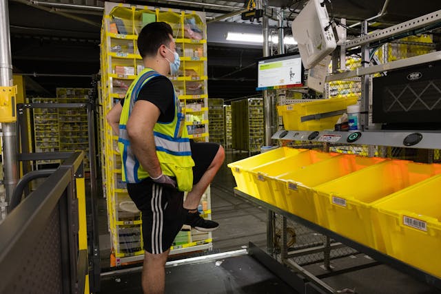 An employee participates in Amazon&apos;s Mind &amp; Body Moments. The program provides hourly visual prompts that guide employees through mental and physical activities lasting 30-60 seconds.
