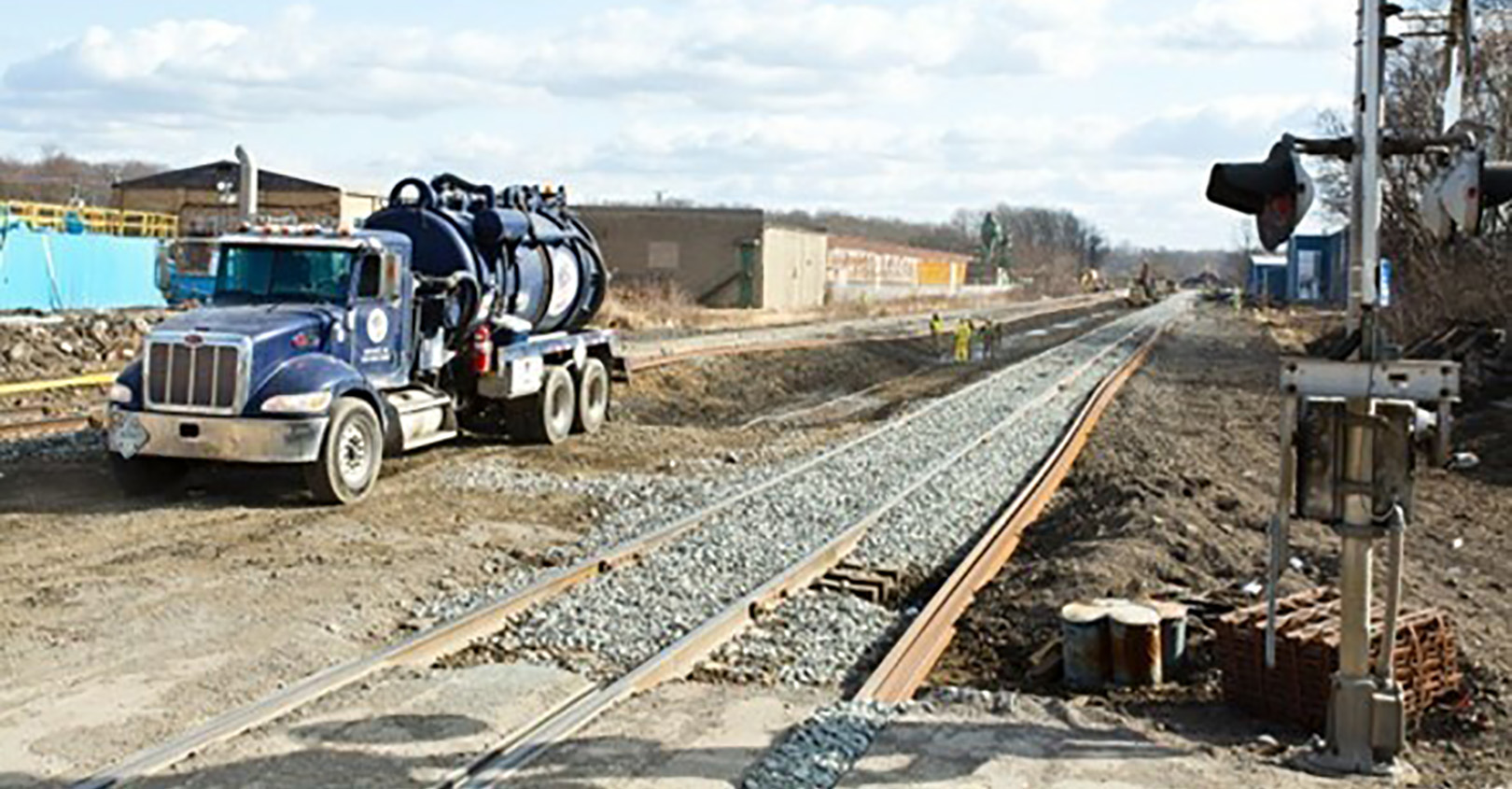 A liquid containment rig helps crews remove standing water from the derailment site to prevent runoff.