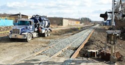 A liquid containment rig helps crews remove standing water from the derailment site to prevent runoff. A liquid containment rig helps crews remove standing water from the derailment site to prevent runoff.