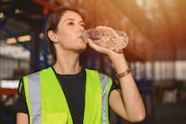 664420310dafe73525fb8ade Woman Drinking Water In Warehouse