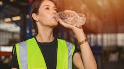 woman_drinking_water_in_warehouse woman_drinking_water_in_warehouse