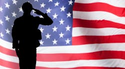 military solider in profile saluting the U.S. flag military solider in profile saluting the U.S. flag