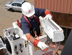 Worker at height using a snap on tool, an example of good fall protection and PPE program Worker at height using a snap on tool, an example of good fall protection and PPE program