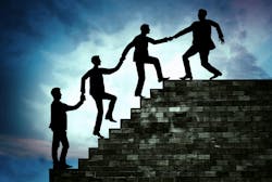 Concept of leadership, with a silhouette of a man pulling his team up to the top of the stairs Concept of leadership, with a silhouette of a man pulling his team up to the top of the stairs