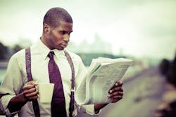 man in a collared shirt and suspenders reading the newspaper and holding a mug man in a collared shirt and suspenders reading the newspaper and holding a mug