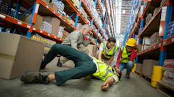 colleagues surrounding injured worker in a warehouse colleagues surrounding injured worker in a warehouse