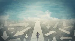 Profile of a woman looking ahead, standing on top of an arrow pointed straight ahead. She is surrounded by arrows in a scattering of directions, suggesting that she is continuing on her path ahead despite the chaos and uncertainty around her.