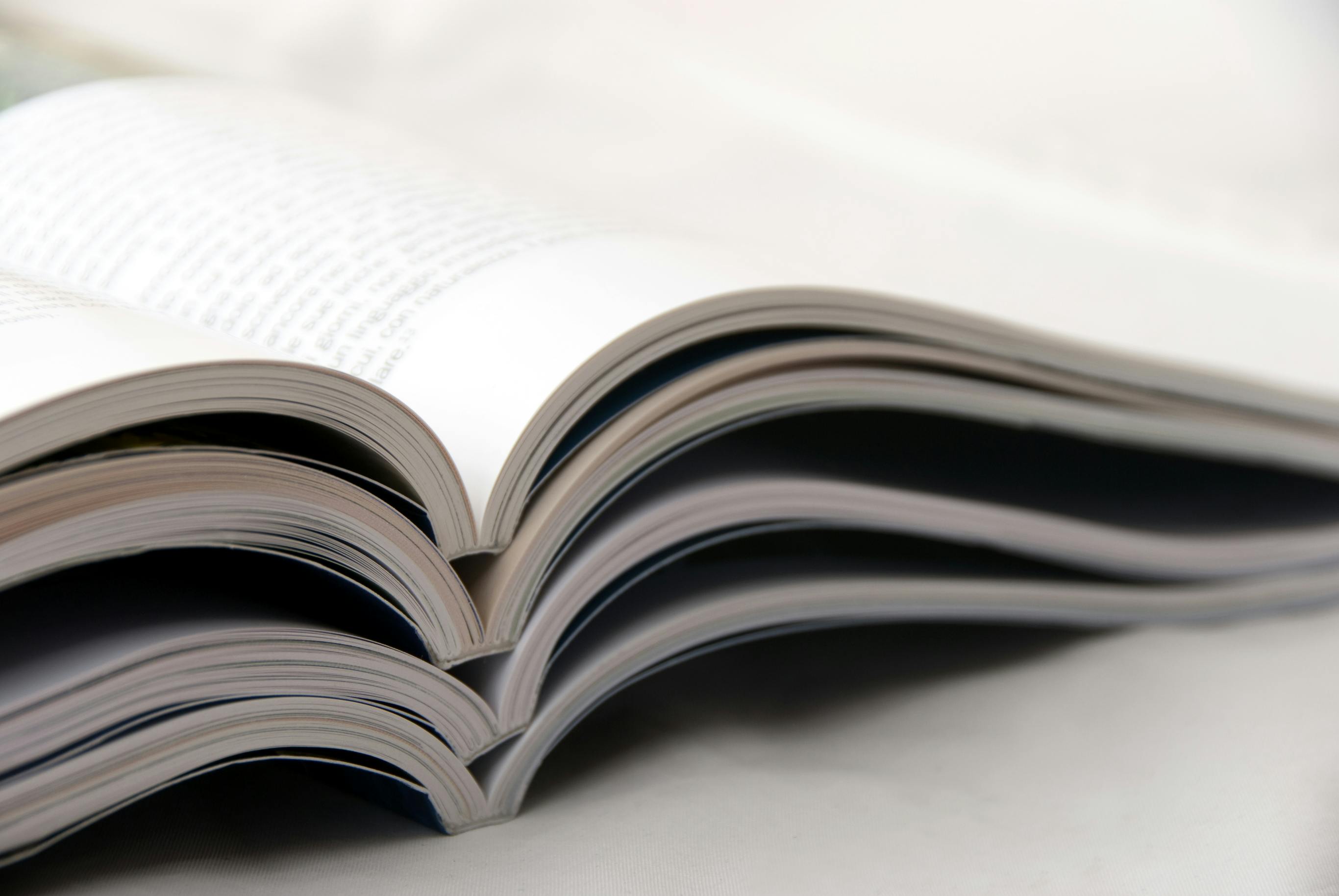 magazines open and stacked on top of one another
