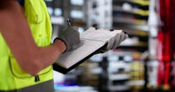 person wearing hi-visibility vest holding a pen and clipboard person wearing hi-visibility vest holding a pen and clipboard