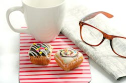still photo of a newspaper, coffee mug, reading glasses and two pastries still photo of a newspaper, coffee mug, reading glasses and two pastries