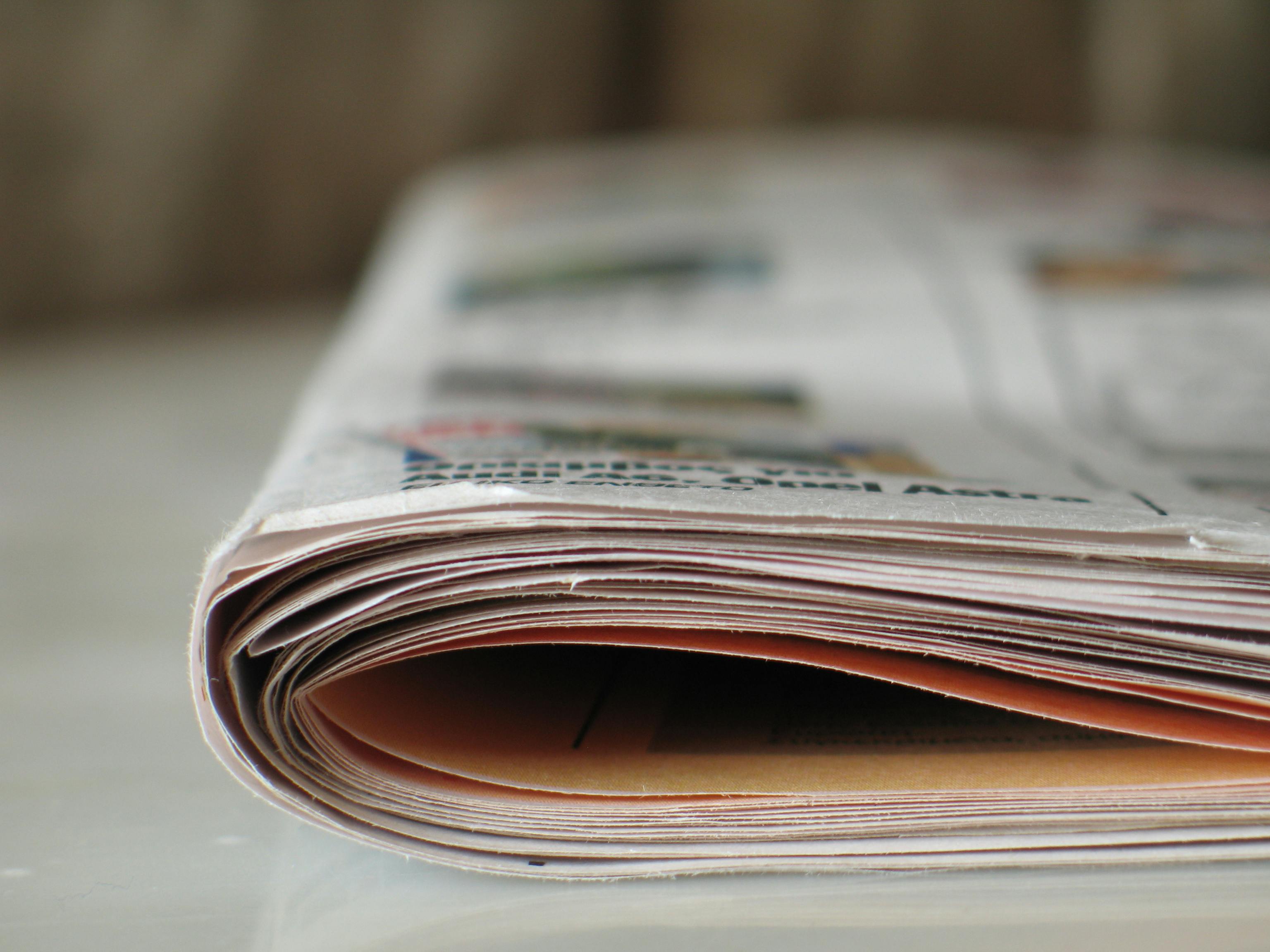 Close-up photograph of a folded tabloid-sized newspaper.