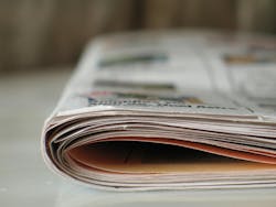 Close-up photograph of a folded tabloid-sized newspaper. Close-up photograph of a folded tabloid-sized newspaper.